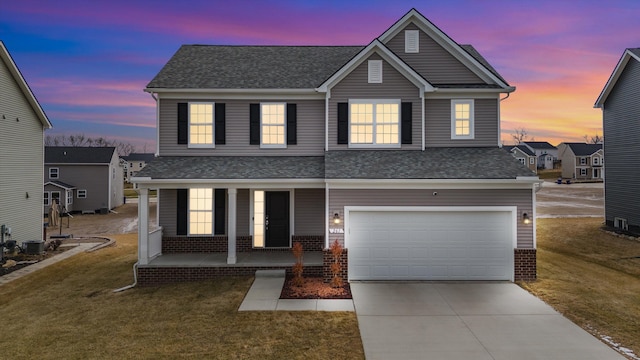 traditional-style home featuring driveway, an attached garage, covered porch, a lawn, and brick siding