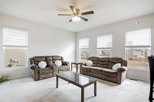 carpeted living area featuring visible vents, a ceiling fan, and baseboards