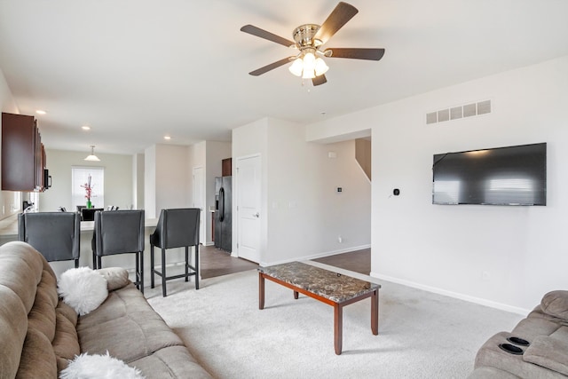 carpeted living room featuring visible vents, recessed lighting, baseboards, and ceiling fan