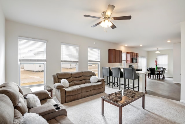 living area with recessed lighting, a healthy amount of sunlight, baseboards, and ceiling fan