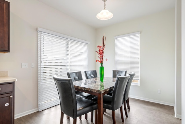 dining room featuring baseboards and wood finished floors