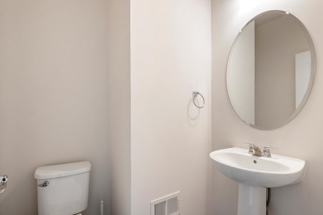 bathroom with toilet and visible vents