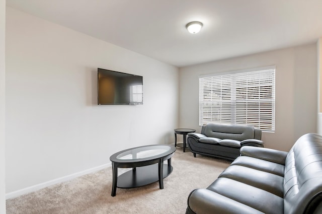 living room with baseboards and light carpet