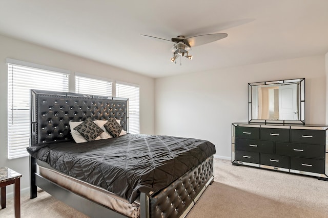 bedroom featuring baseboards, light carpet, and a ceiling fan