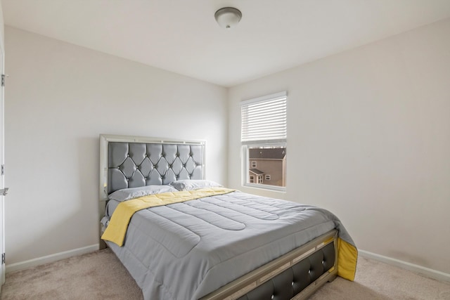 carpeted bedroom featuring baseboards