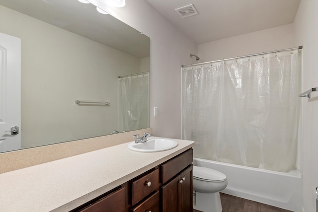 full bathroom with vanity, wood finished floors, shower / bathtub combination with curtain, visible vents, and toilet