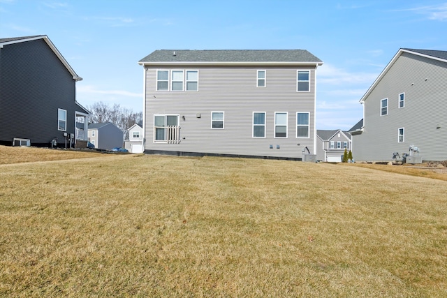 rear view of house featuring a lawn