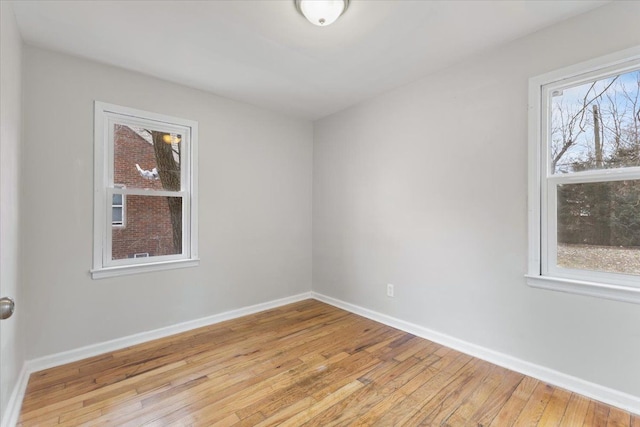 unfurnished room featuring light wood-type flooring and baseboards