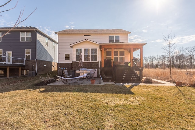 back of house with a lawn, a patio, and stairs
