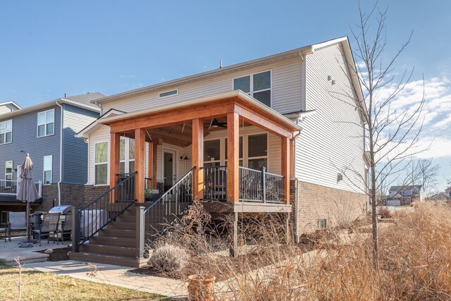 view of front of home featuring brick siding and a patio
