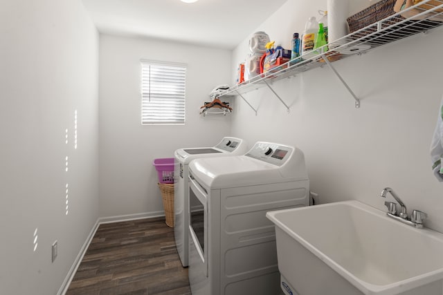laundry room with a sink, dark wood-style flooring, baseboards, washer and dryer, and laundry area