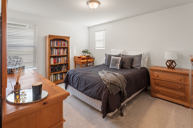 bedroom featuring light colored carpet