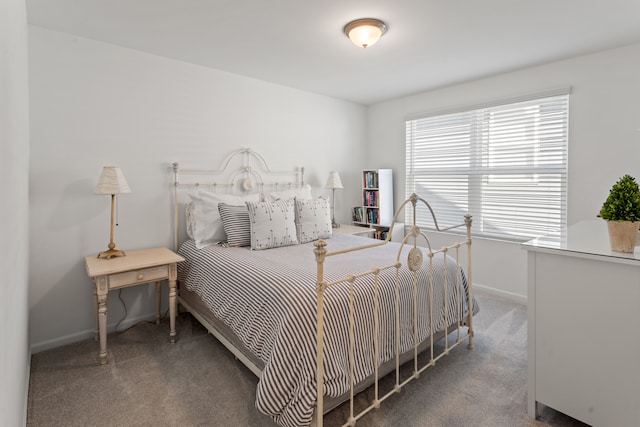bedroom featuring baseboards and carpet floors