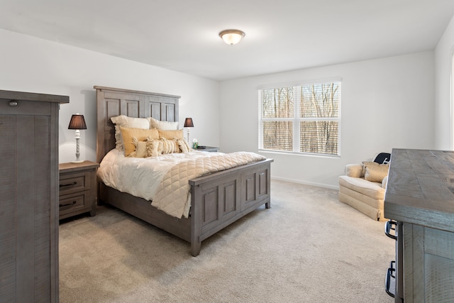 bedroom featuring baseboards and light carpet