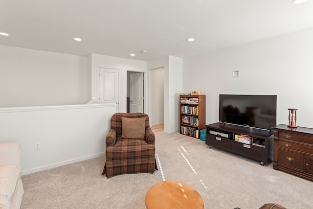living area featuring light carpet and recessed lighting