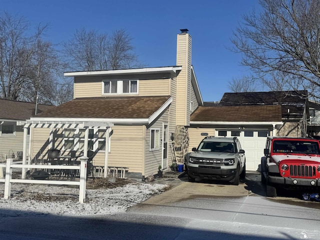 view of side of home with an attached garage and a chimney