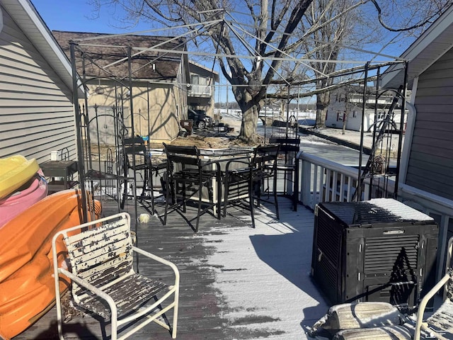 deck featuring central AC unit and outdoor dining area