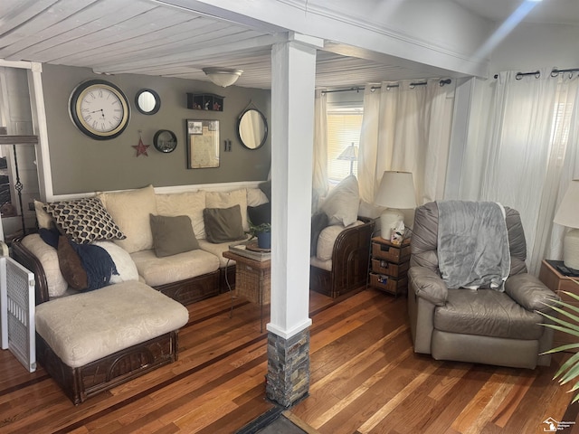 living area with wood finished floors and ornate columns