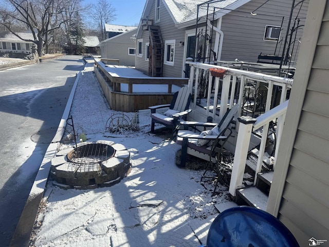 view of patio featuring a hot tub, a deck, and an outdoor fire pit