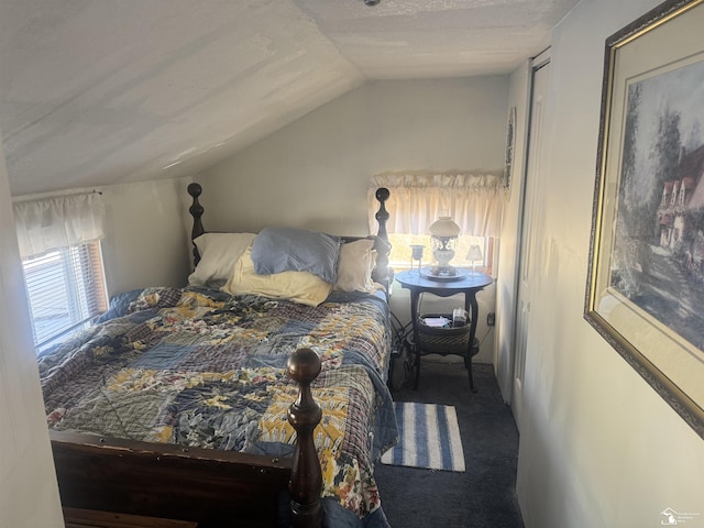 bedroom featuring lofted ceiling and carpet