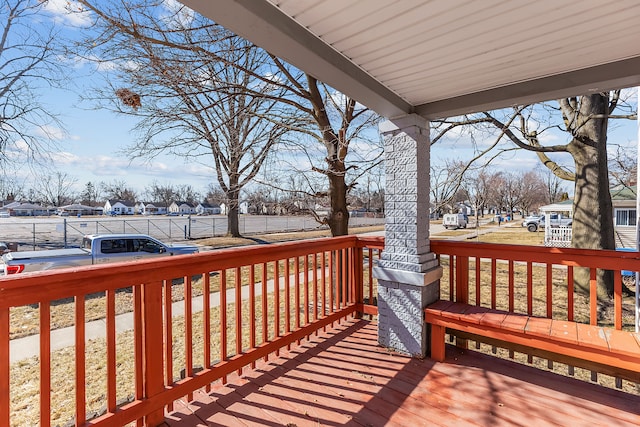 wooden deck featuring covered porch and a residential view