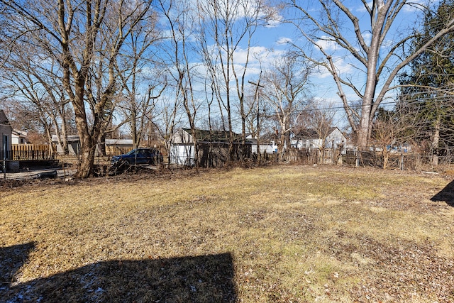 view of yard featuring an outbuilding and fence