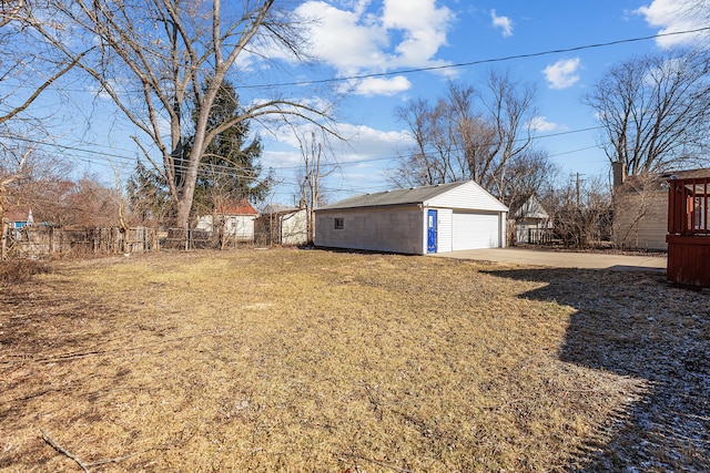 view of yard with an outbuilding, fence, and a garage