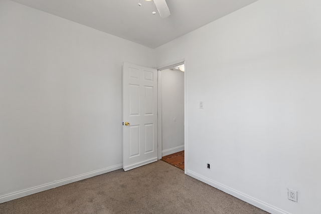 carpeted empty room with baseboards and ceiling fan