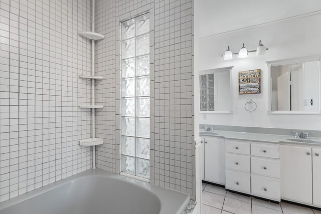 full bath featuring a sink, double vanity, and tile patterned floors