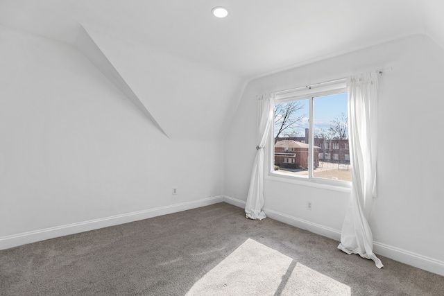 empty room featuring vaulted ceiling, carpet flooring, recessed lighting, and baseboards