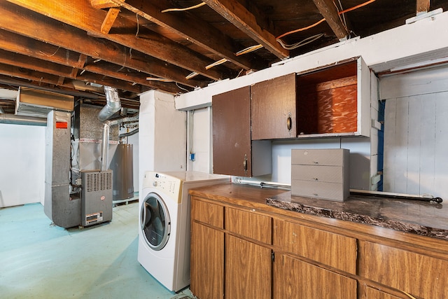 laundry area featuring heating unit, laundry area, washer / dryer, and gas water heater