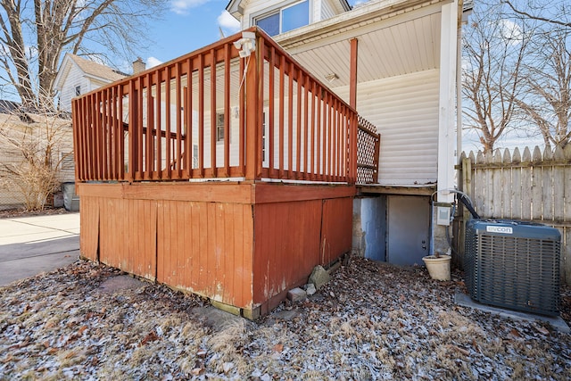 view of side of home with cooling unit and fence