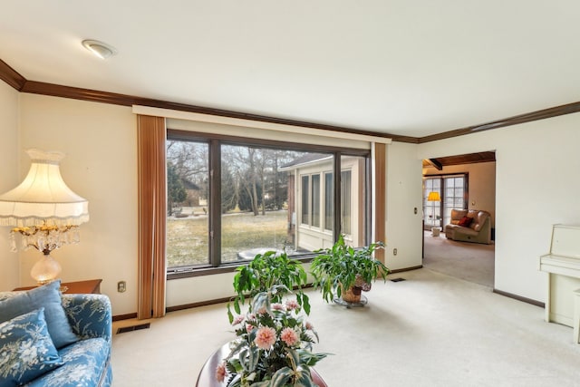 living room with visible vents, light carpet, baseboards, and crown molding