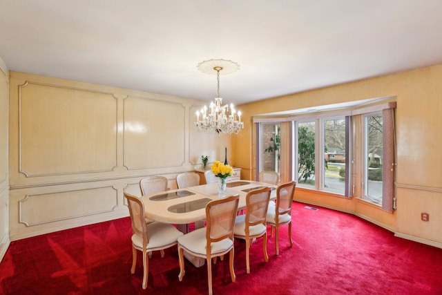 carpeted dining area featuring visible vents and a notable chandelier