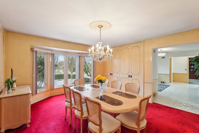 dining space with a notable chandelier