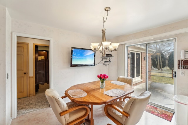 dining area featuring an inviting chandelier