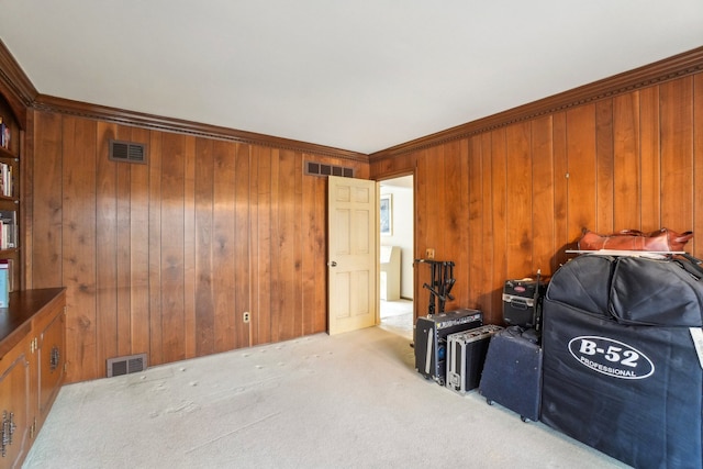 interior space featuring visible vents, carpet floors, and wooden walls