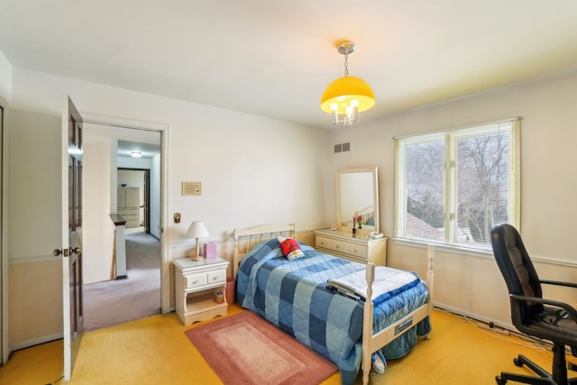 bedroom with visible vents and light carpet