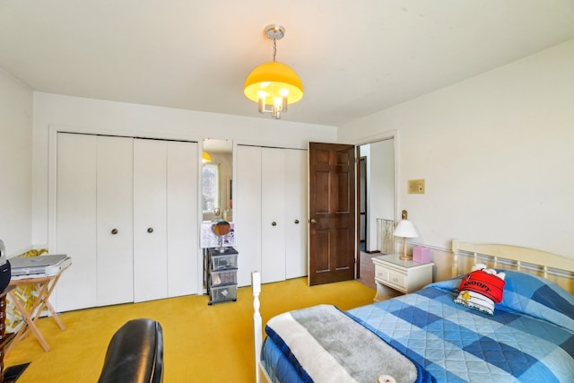 carpeted bedroom with two closets