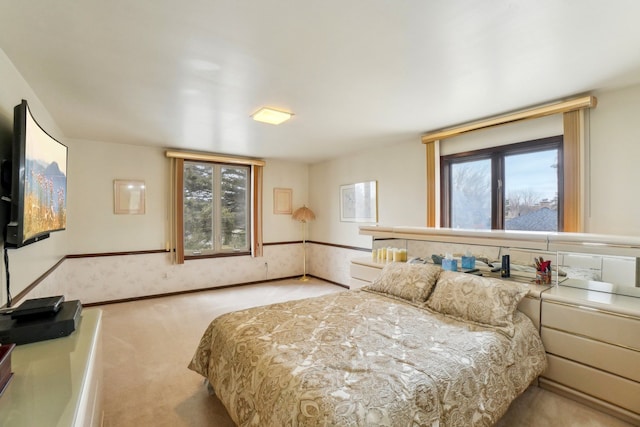 bedroom featuring multiple windows, baseboards, and carpet floors