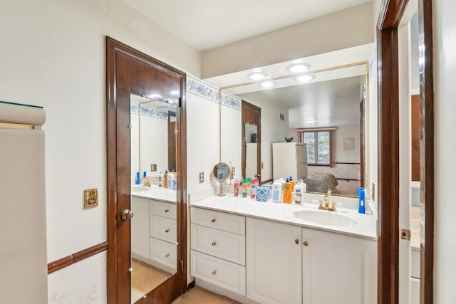 full bathroom with vanity and connected bathroom