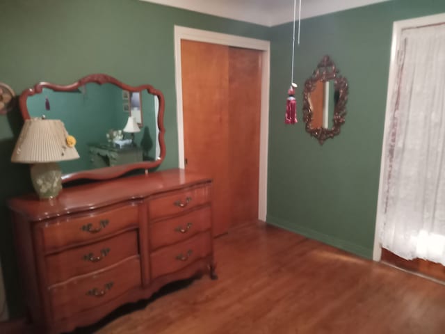 bedroom with baseboards and wood finished floors