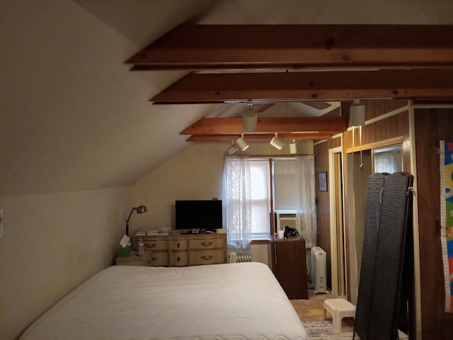 bedroom featuring radiator heating unit and lofted ceiling with beams