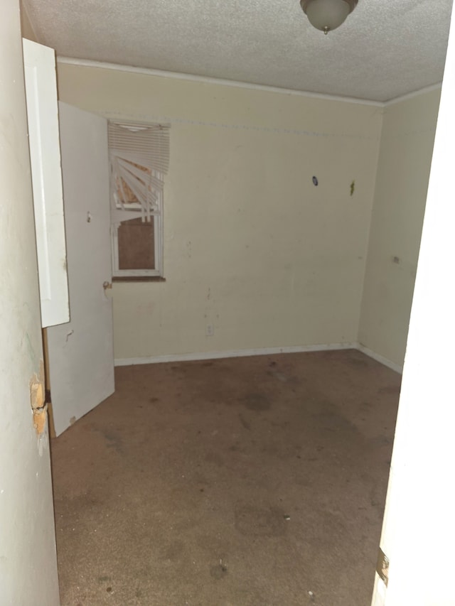 unfurnished room with a textured ceiling