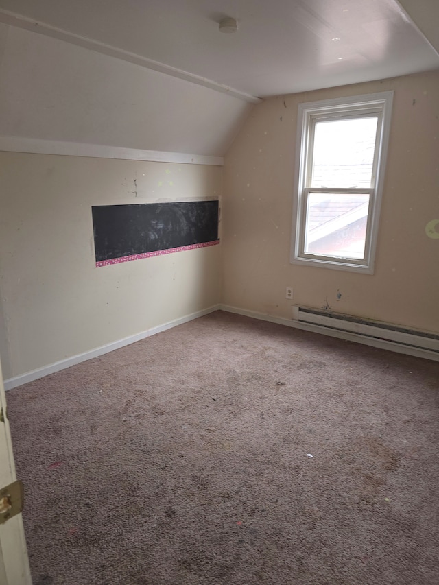 additional living space with baseboards, baseboard heating, carpet flooring, and vaulted ceiling