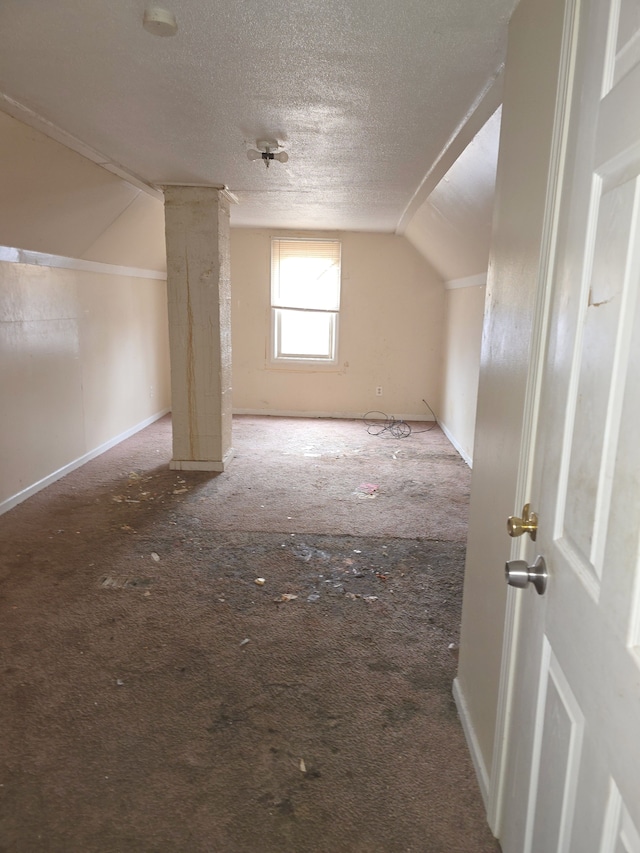 bonus room featuring vaulted ceiling and a textured ceiling