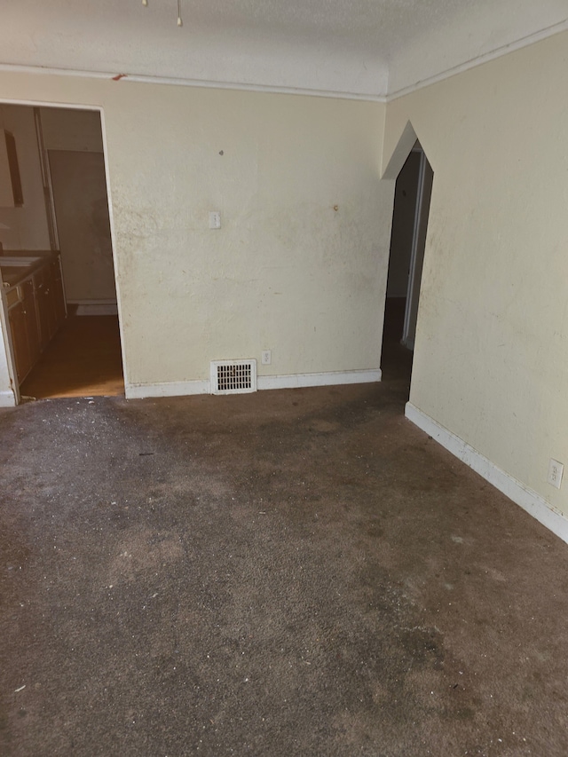 spare room with visible vents and a textured ceiling