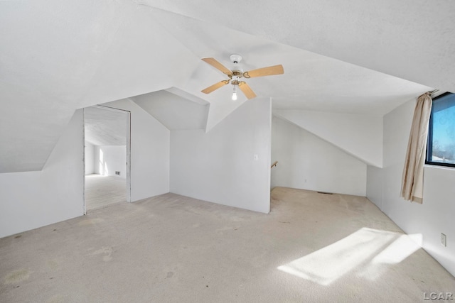 additional living space with vaulted ceiling and carpet