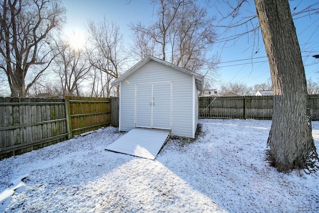 exterior space with an outbuilding, a storage shed, and a fenced backyard