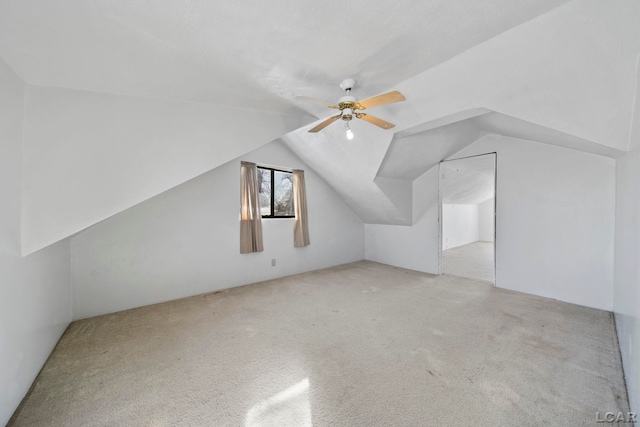 additional living space featuring lofted ceiling, carpet flooring, and a ceiling fan